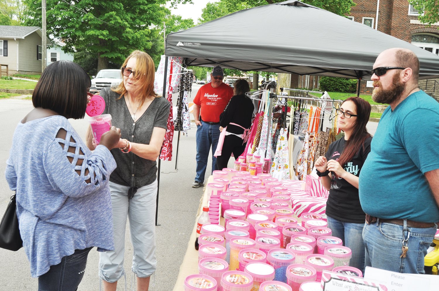 Glenda Slater, second from left, hands Mildred Sanders a fragrance to smell as Megan Slater (no relation to Glenda) and Jeremiah Wesley look on at the Pink Zebra booth at the Waynetown Street Fair in 2021. This year's festival, sponsored by the Waynetown Merchants Association, is set for May 14.